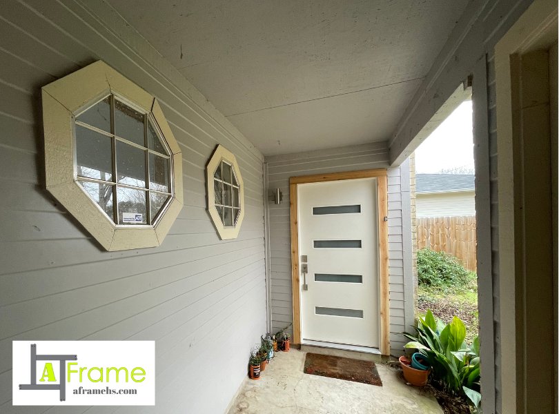 Modern entry door and octagon accent windows installed by A Frame