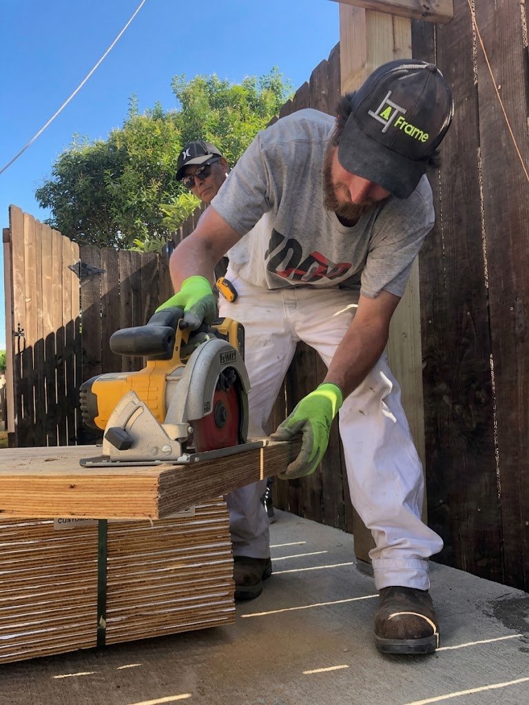 A Frame crew cutting lumber on a build